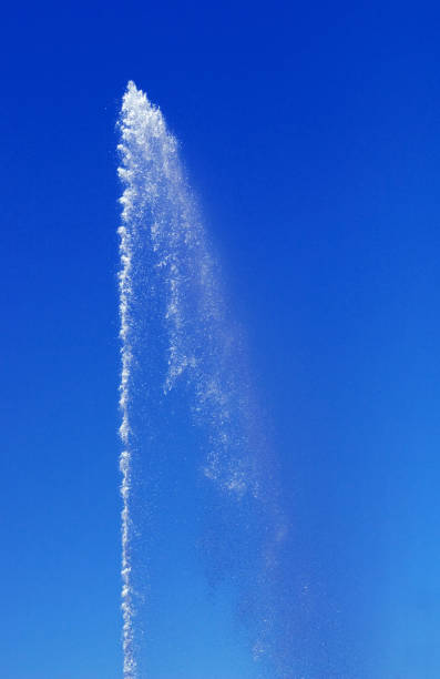 Water from a fountain in the blue sky