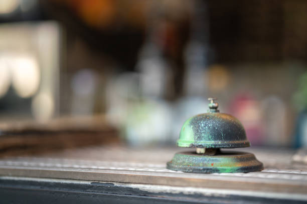 A metal service ringing bell in retro style that placed on the receiption desk. Object photo. Selective focus.