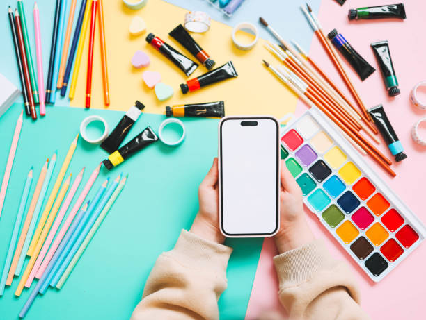 istock A child with a phone in his hands during an online lesson, space for your screenshot 1987632505