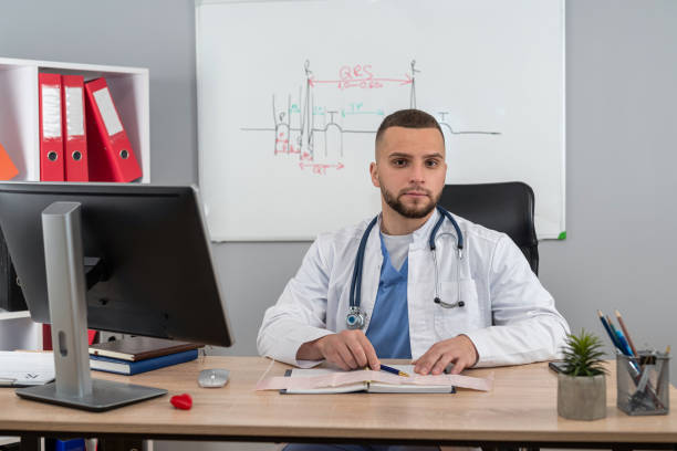 istock Young doctor or general practitioner sitting at workplace in hospital clinic 1987634665