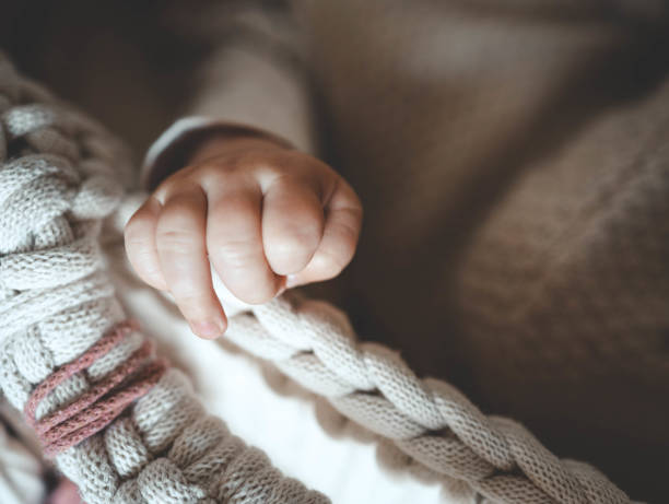 hand of a newborn baby close-up, concept of happy motherhood - human pregnancy earth globe mother стоковые фото и изображения