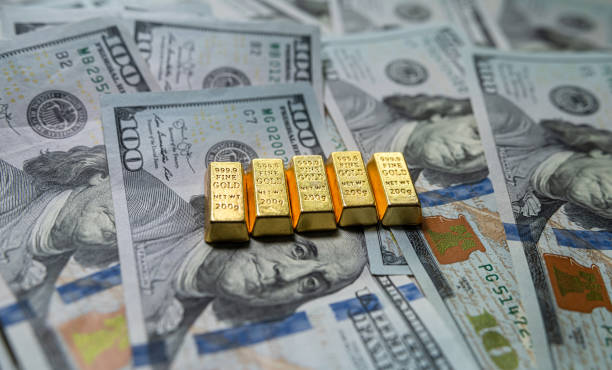 istock Group of gold bar on US dollar banknotes background 1987648590
