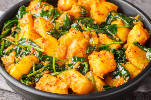 istock Saag Aloo Indian style spinach and potatoes curry in a bowl closeup. Horizontal 1987656214