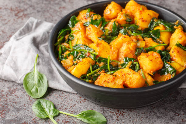 istock Aloo Saag South Asian curry made with potatoes and spinach with spices closeup on the bowl. Horizontal 1987658943