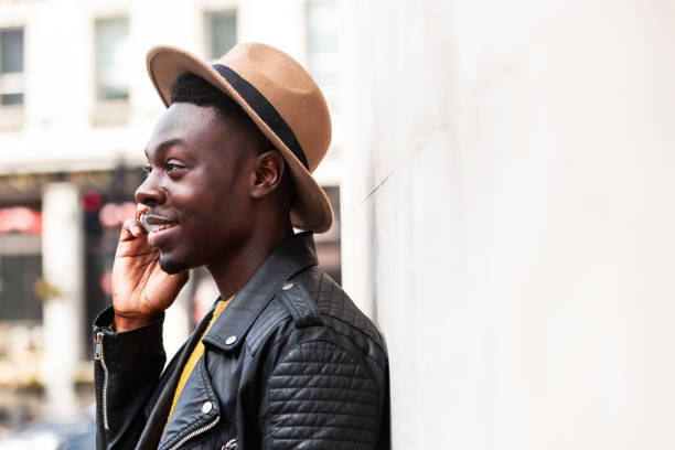 istock Happy black man talking on the phone and smiling 1987693516