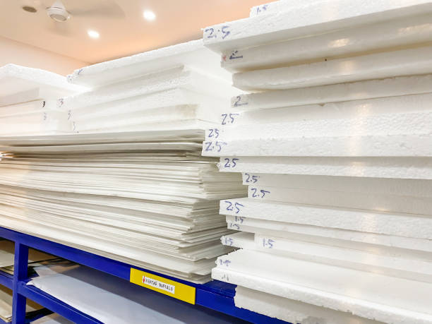 Stack of white foam board sheets of various thicknesses displayed on a shelf in a stationery shop. Material used for mounting of photographic prints, making scale models, and painting.
