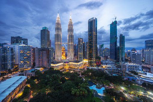 Evening view of the Kuala Lumpur city center with Petronas towers and park.