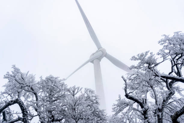 low angle view of wind turbine in cold winter.