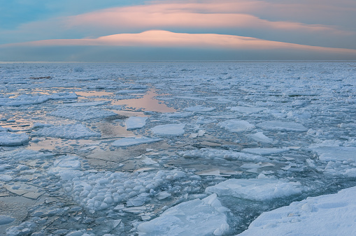Winter landscape of the frozen shoreline of Lake Michigan at sunset, Saugatuck Dunes State Park, Michigan, USA
