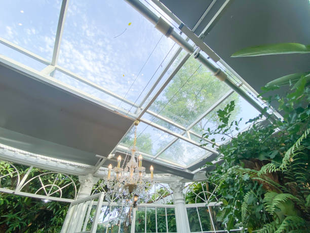 istock Modern house roofs use automatic mechanical systems to open and close. Transparent roof with natural light from the sun to light the house during the day. Concept for urban gardening and indoor garden 1987760895