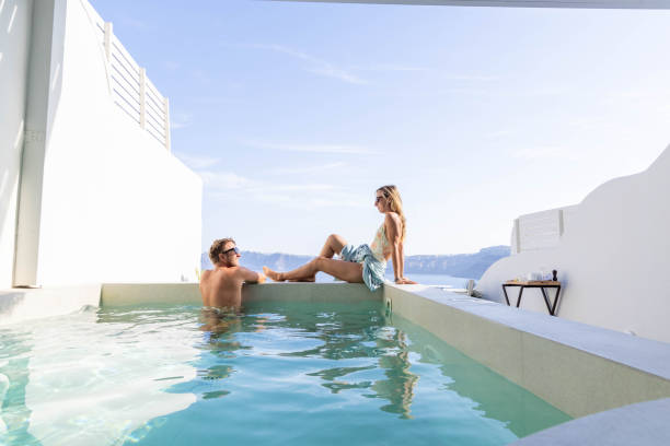 istock Greek Getaway: Young Couple Relaxing by Private Villa Pool with Sea View 1987766686