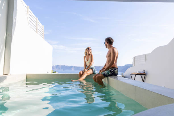 istock Greek Getaway: Young Couple Relaxing by Private Villa Pool with Sea View 1987767033