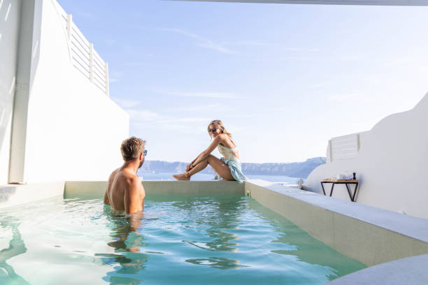 istock Greek Getaway: Young Couple Relaxing by Private Villa Pool with Sea View 1987768269