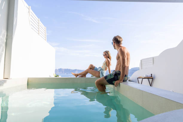 istock Greek Getaway: Young Couple Relaxing by Private Villa Pool with Sea View 1987768811