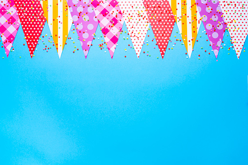 Colorful bunting and confetti background. Copy space