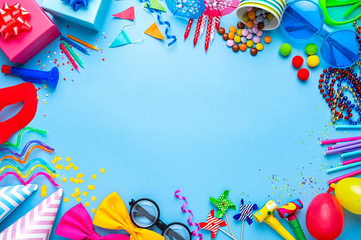 Birthday party or carnival accessories on blue background. Copy space