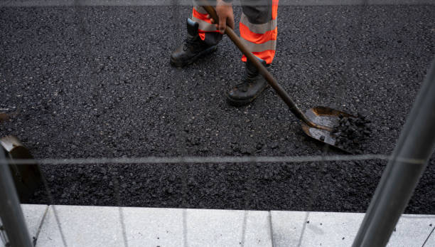 istock Worker levelling fresh asphalt on a road construction 1987786498