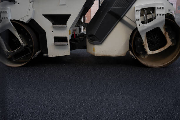 A big vibration  roller compacting asphalt on a new road