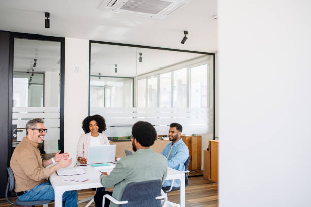 istock A diverse team of professionals gathers around a table for a collaborative session 1987788611