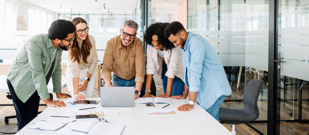 istock A panoramic view of a motivated team intensely focused on a computer screen 1987788771
