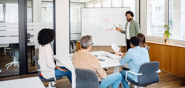istock Colleagues engage in a lively exchange of ideas in an office 1987789301