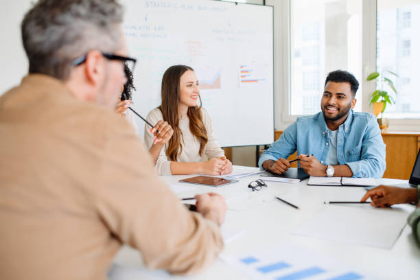istock Colleagues engage in a lively exchange of ideas in an office 1987789314