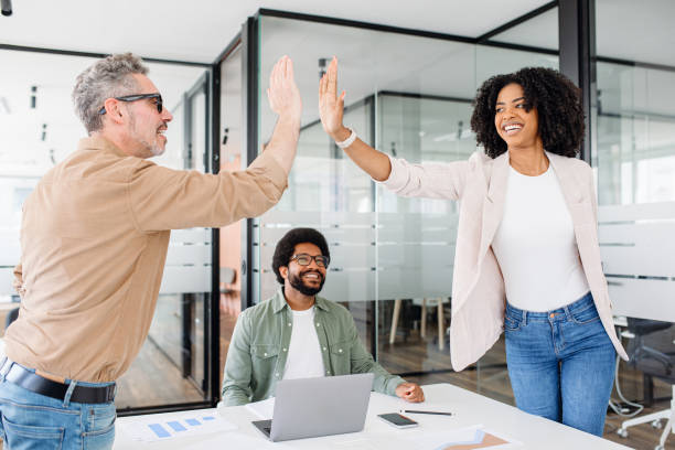 istock The colleagues exchange a high-five 1987789316