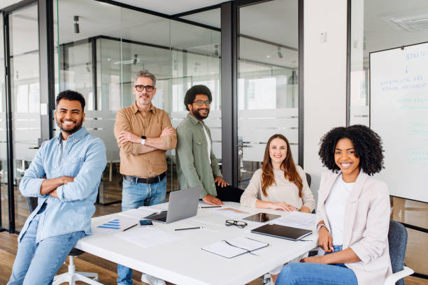 istock A diverse group of five colleagues beams with pride in their office 1987789319