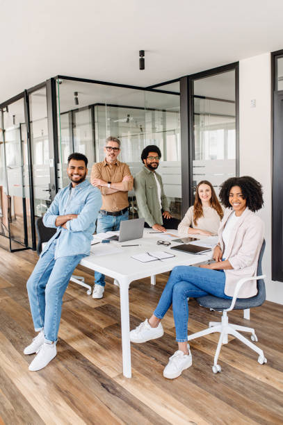 istock A diverse group of five colleagues beams with pride in their office 1987789326