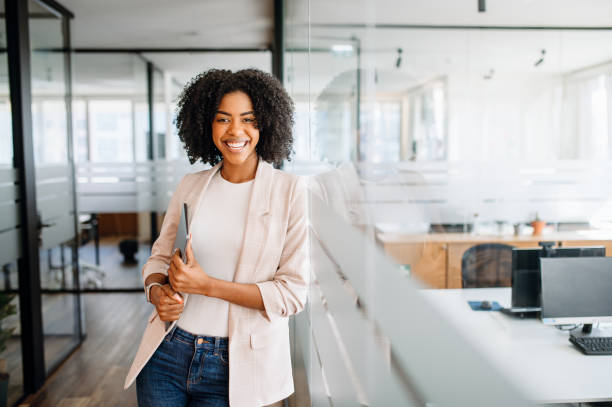 istock A young professional woman stands confidently in a modern office 1987789337