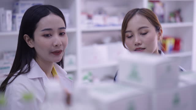 Pharmacy give advise and detail to patient customer in drug store.