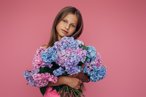 Cute teenager girl holding flowers