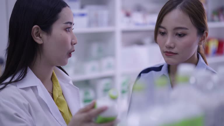 Pharmacy give advise and detail to patient customer in drug store.