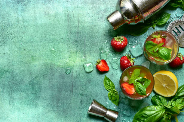 istock Fresh ingredients and props for making summer cold cocktail strawberry mojito. Top view with copy space. 1987801717