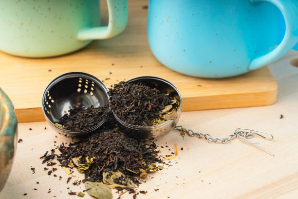 Herbal tea in a metal strainer on a wooden table ???????? ??? kusmi tea stock pictures, royalty-free photos & images