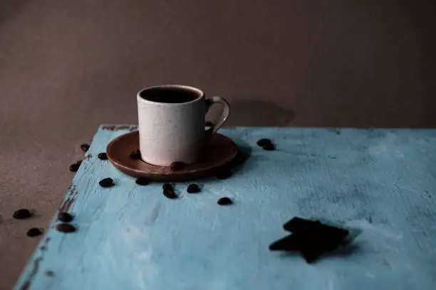 Photo of cup of turkish coffee, traditional hot beverage drink, beans, blue wooden background, fortune telling reading