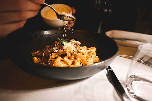 Traditional Italian cuisine. Appetizing pasta tagliatelle spaghetti with tomato sauce and beff in a restaurant.