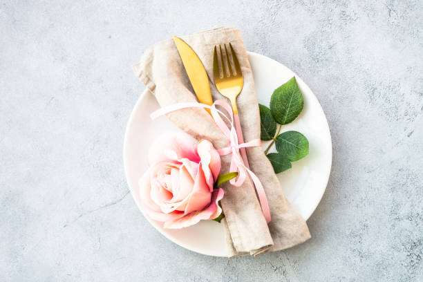 istock Table setting with white plate, cutlery and flowers. 1987872815
