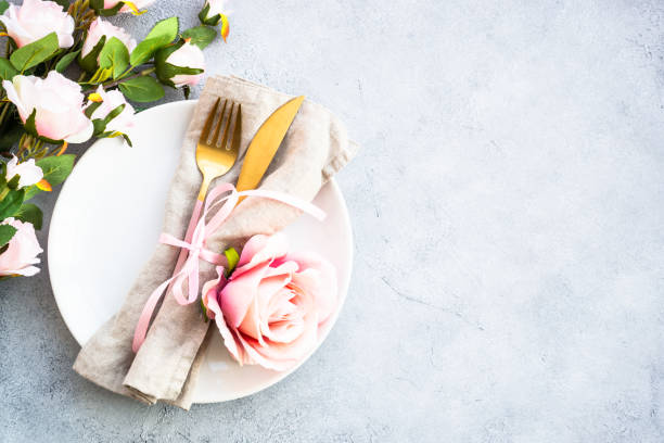 istock Table setting with white plate, cutlery and flowers. 1987872816