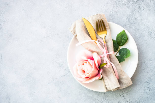 istock Table setting with white plate, cutlery and flowers. 1987872817