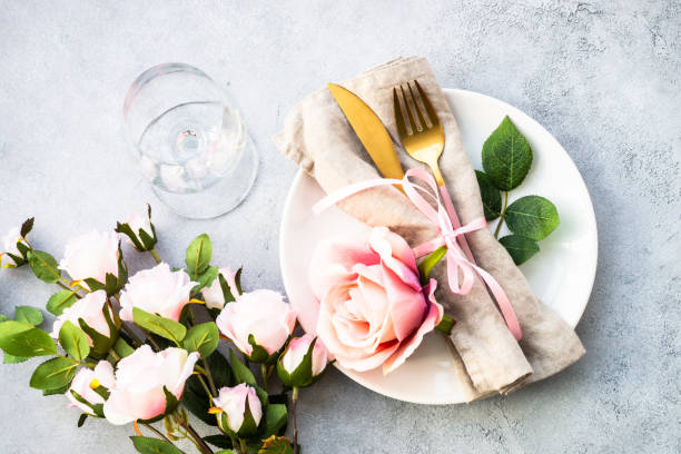 istock Table setting with white plate, cutlery and flowers. 1987872831