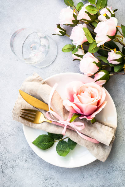 istock Table setting with white plate, cutlery and flowers. 1987873340