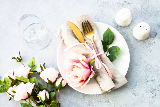 istock Table setting with white plate, cutlery and flowers. 1987873347