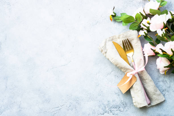 istock Table setting with white plate, cutlery and flowers. 1987873352