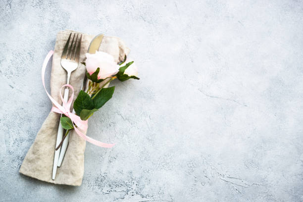 istock Table setting with white plate, cutlery and flowers. 1987873355