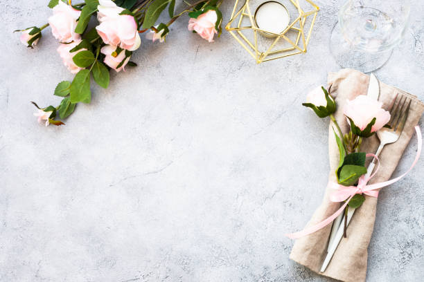 istock Table setting with white plate, cutlery and flowers. 1987873868