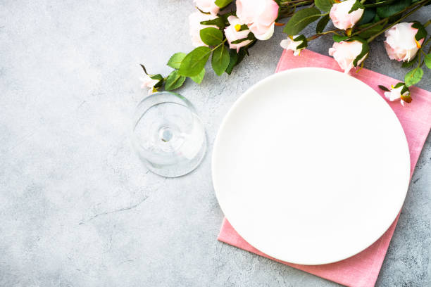 istock Table setting with white plate, cutlery and flowers. 1987873871