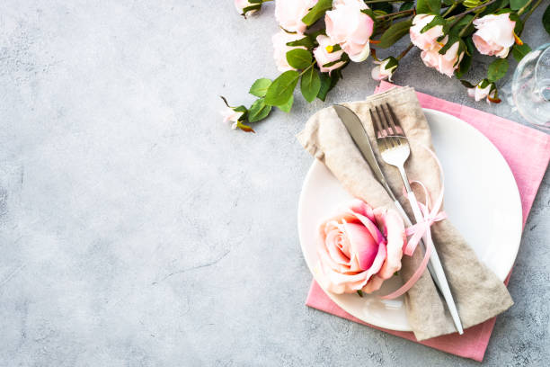 istock Table setting with white plate, cutlery and flowers. 1987873874