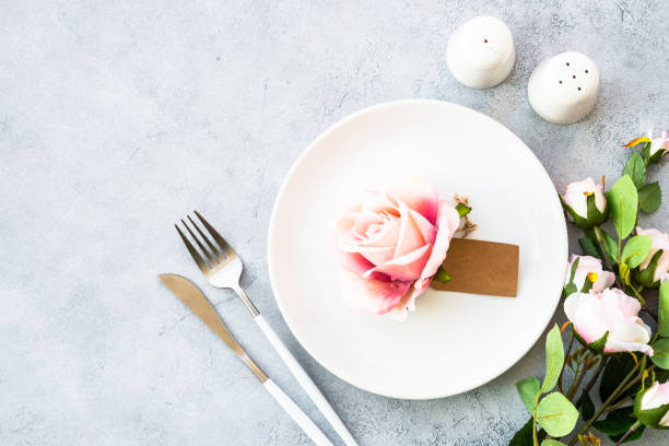 istock Table setting with white plate, cutlery and flowers. 1987874384