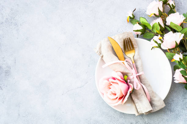 istock Table setting with white plate, cutlery and flowers. 1987874396